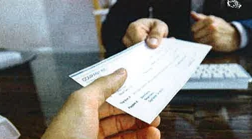 A check being handed to a client