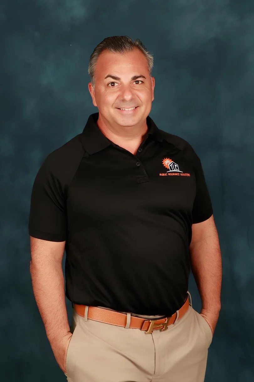 Johnny Pilla Jr, owner of Tropical Loss Consultants, wearing the TLC company polo